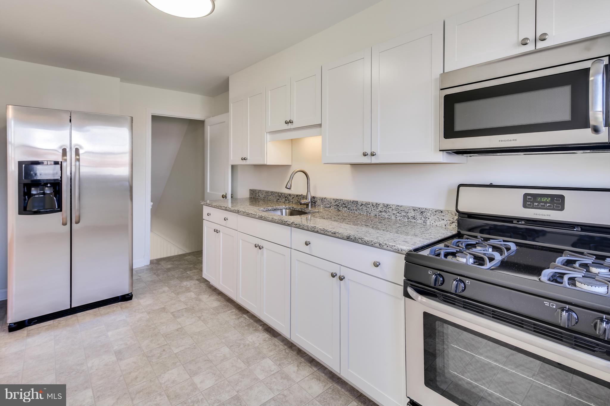 1512 Langford Road Baltimore, MD 21207 - Photo 10 of 30 a kitchen with granite countertop cabinets stainless steel appliances and a counter space