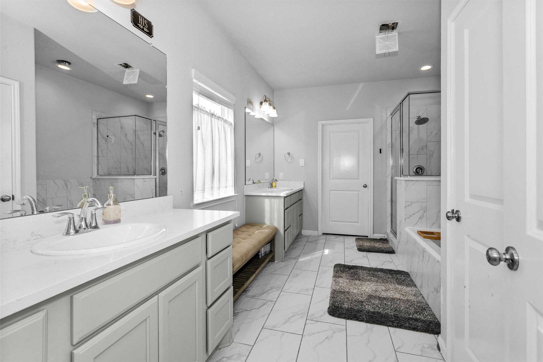 2375 Hagerman Road Conroe, TX 77384 - Photo 20 of 35 Very pretty primary bath with double sinks and his and hers cabinet areas.