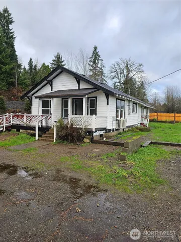 a front view of a house with a yard and trees