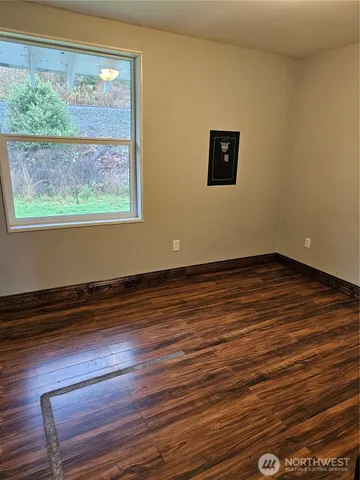 a view of a room with wooden floor and window
