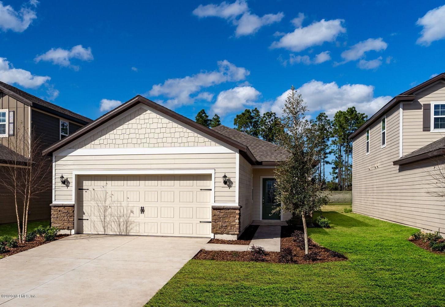 98 Tree Frog Way St. Augustine, FL 32095 - Photo 1 of 19 a front view of a house with a garden and yard