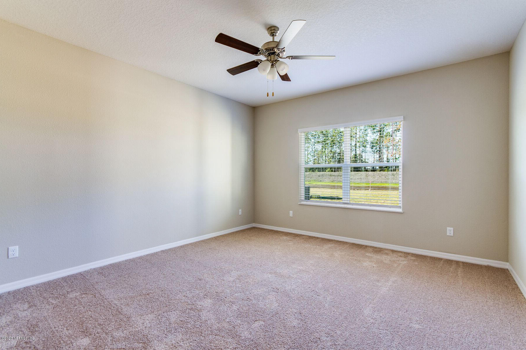 98 Tree Frog Way St. Augustine, FL 32095 - Photo 11 of 19 an empty room with windows and ceiling fan