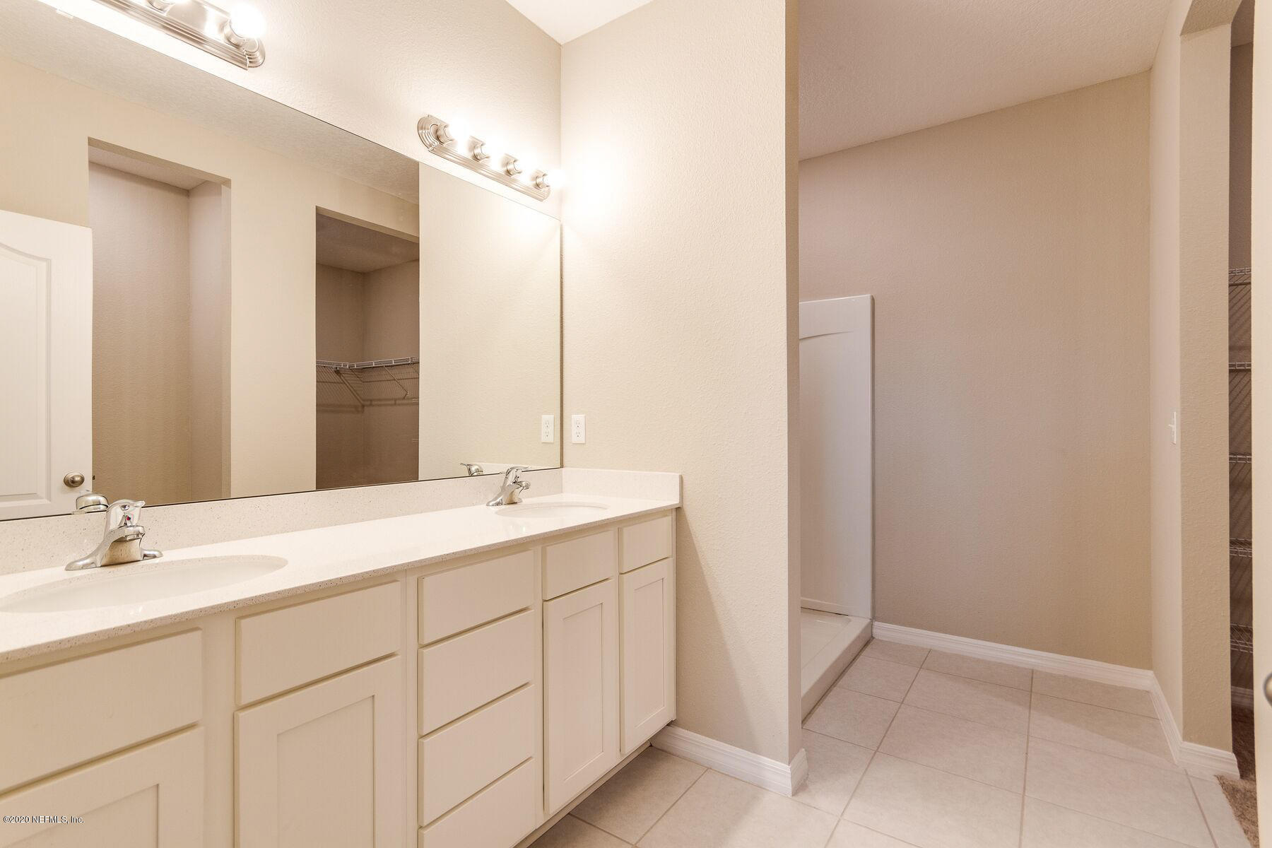 98 Tree Frog Way St. Augustine, FL 32095 - Photo 12 of 19 a bathroom with a double vanity sink and mirror