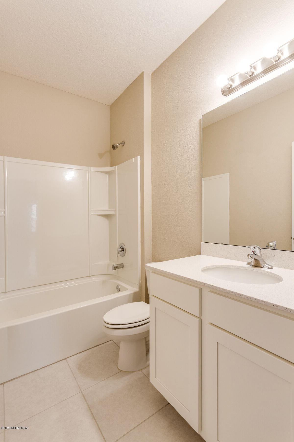 98 Tree Frog Way St. Augustine, FL 32095 - Photo 15 of 19 a bathroom with a sink a toilet and a large mirror