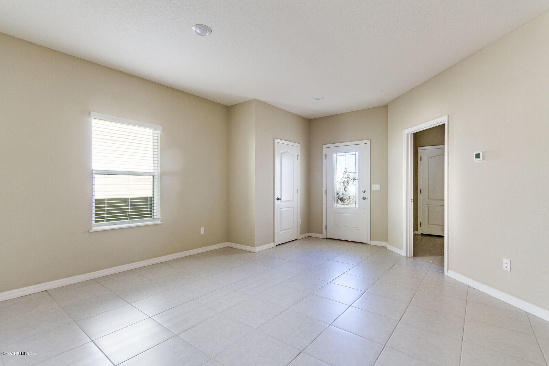 98 Tree Frog Way St. Augustine, FL 32095 - Photo 3 of 19 a view of an empty room with a window
