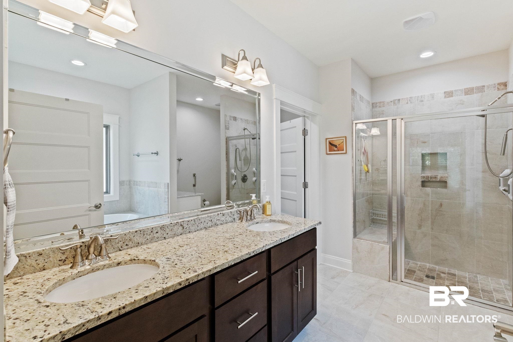 192 Mark Twain Loop Foley, AL 36535 - Photo 23 of 42 Bathroom with plus walk in shower, dual vanity, and tile patterned floors