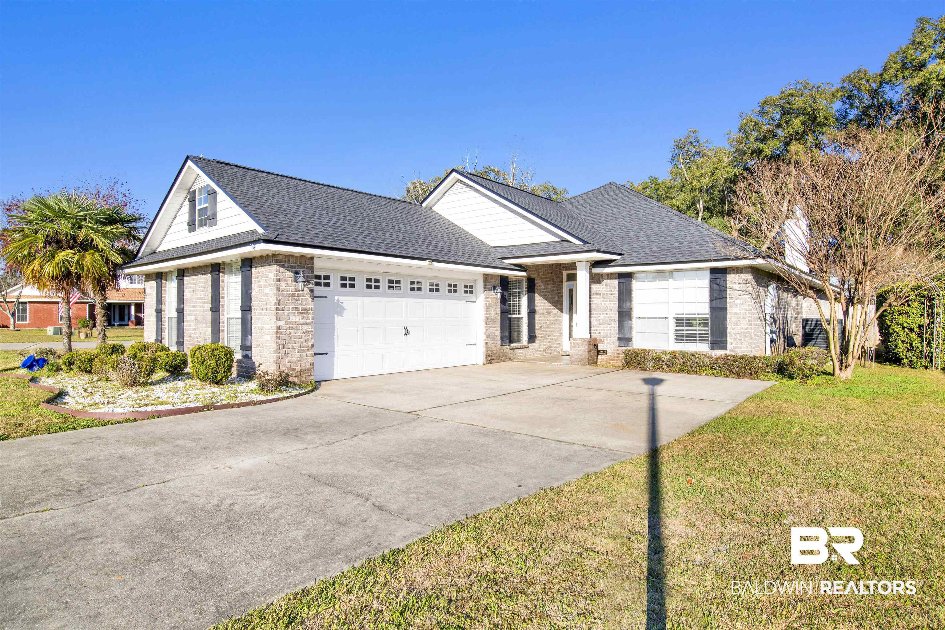 314 Blackfriars Street Fairhope, AL 36532 - Photo 2 of 25 Single story home featuring a garage, driveway, a front lawn, and brick siding