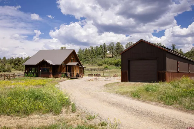 a front view of house with yard and car parked