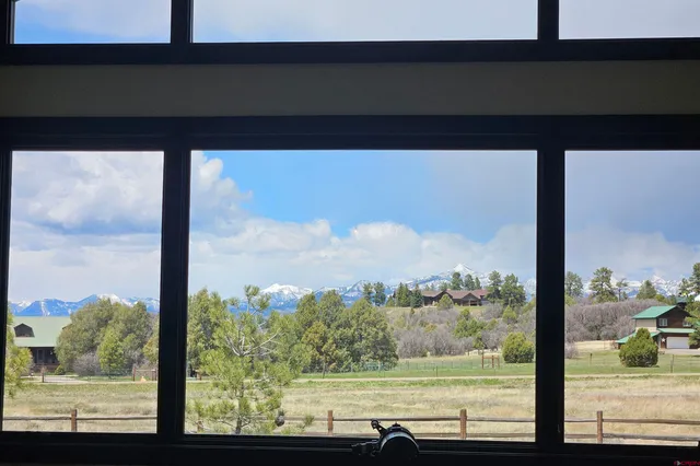 a living room with furniture fireplace and wooden floor