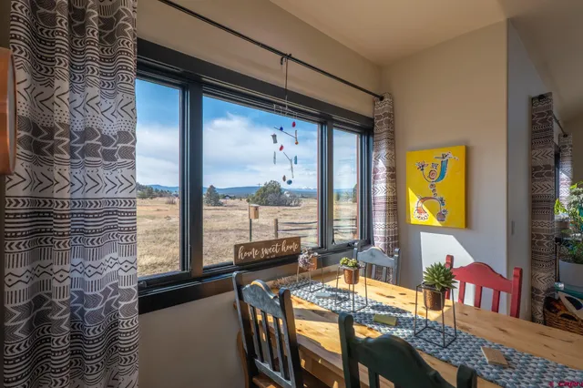 a spacious bedroom with a bed and wooden floor