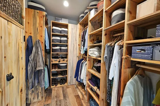 a house view with a seating space and wooden floor