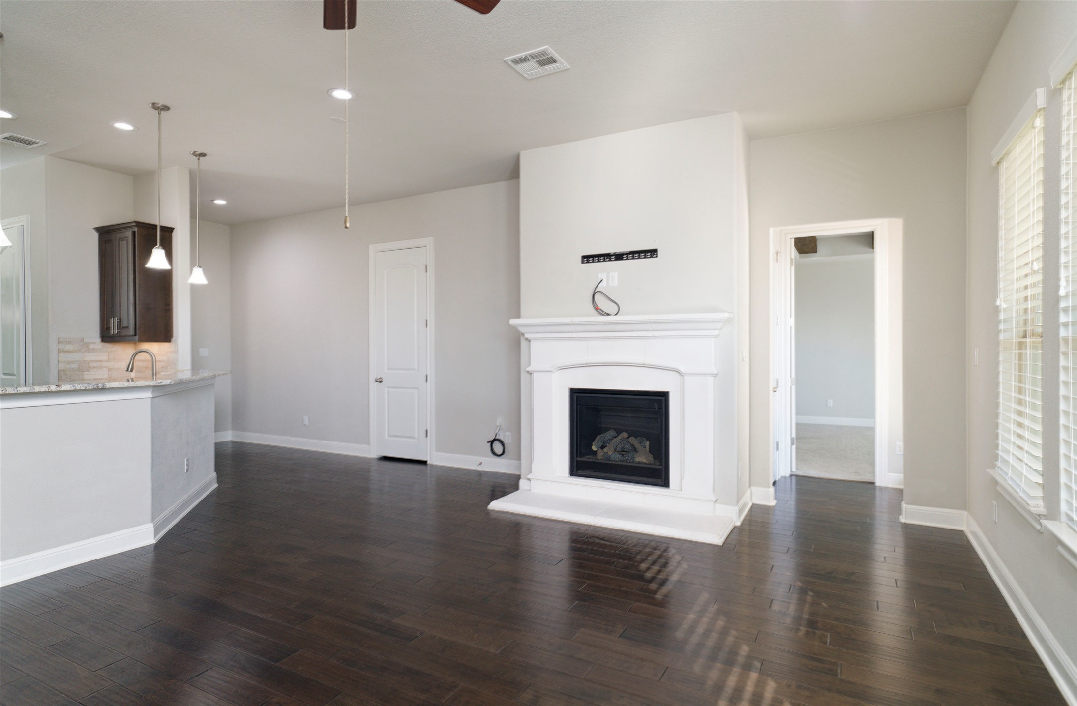 4001 Goodnight Trail Leander, TX 78641 - Photo 10 of 35 an empty room with wooden floor and a fireplace