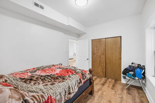 a bed sitting in a bedroom next to a window