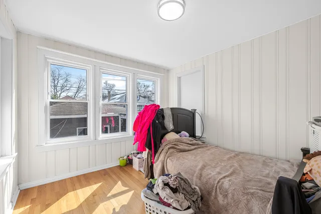 a storage room with a sink and wooden floor