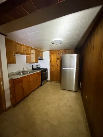 a view of a livingroom with an empty space and a window