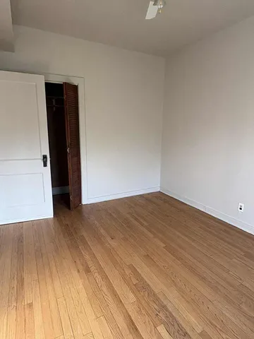 a bedroom with a bed and a night stand