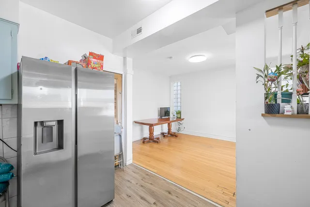 a view of a workspace with furniture and wooden floor