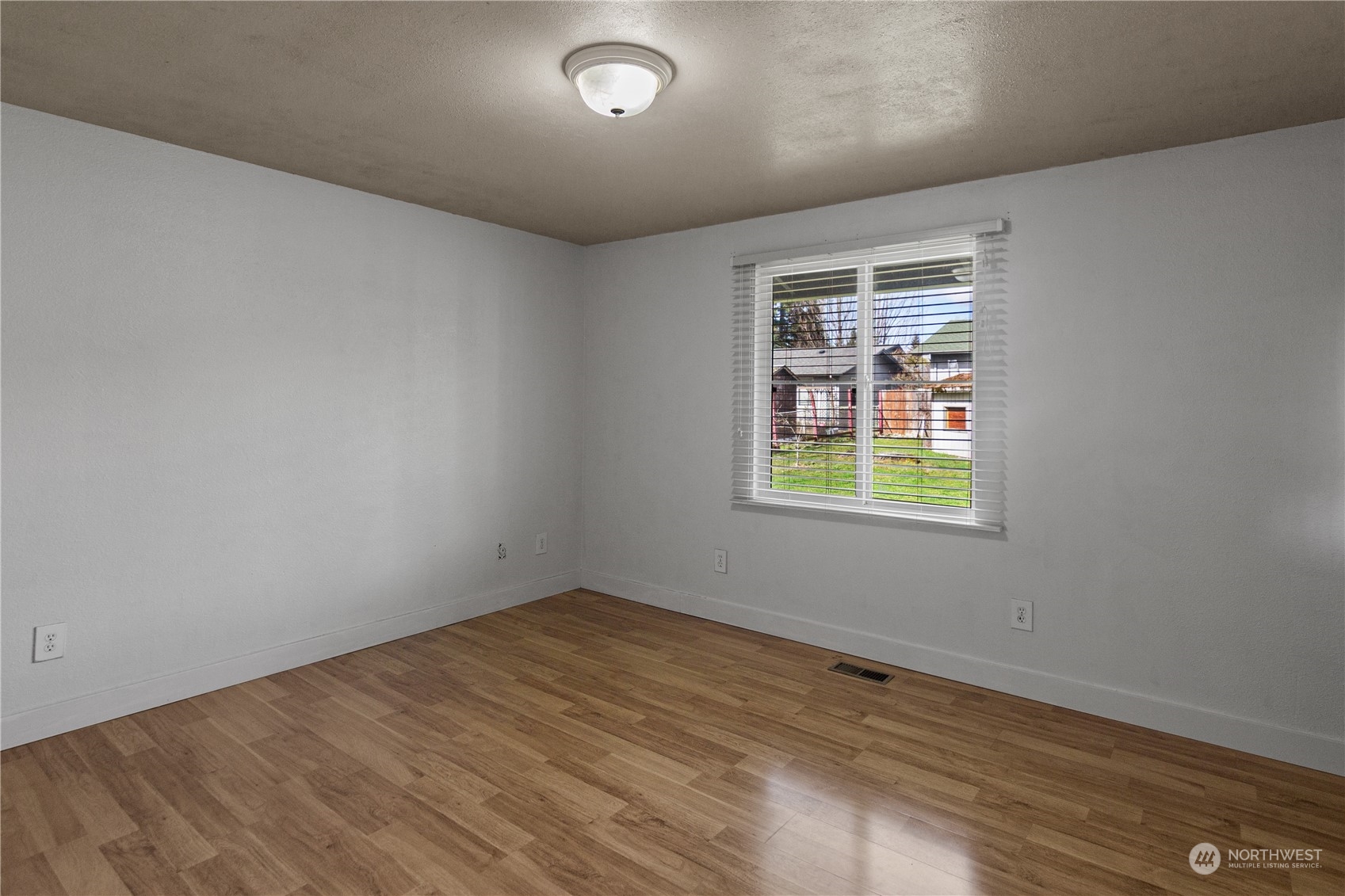 4706 Northeast 18th Street Renton, WA 98059 - Photo 19 of 26 an empty room with wooden floor and windows