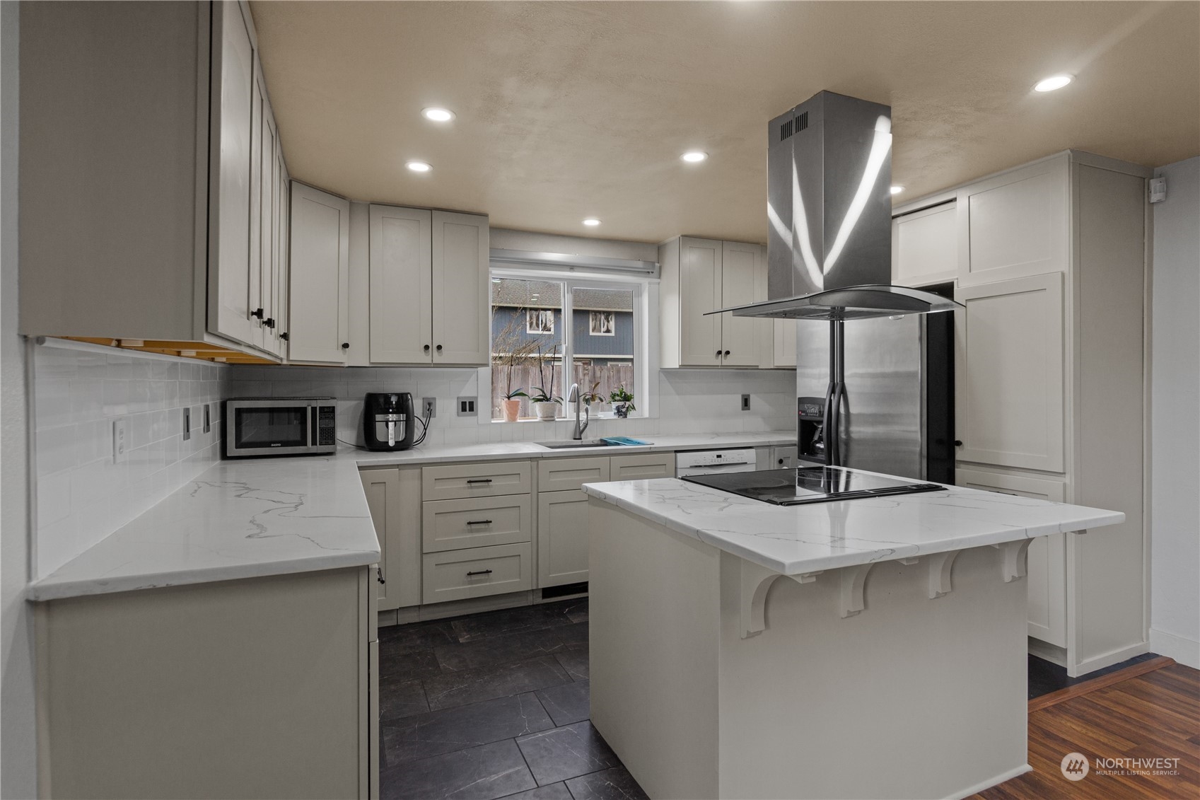 4706 Northeast 18th Street Renton, WA 98059 - Photo 8 of 26 a kitchen with white cabinets appliances and sink