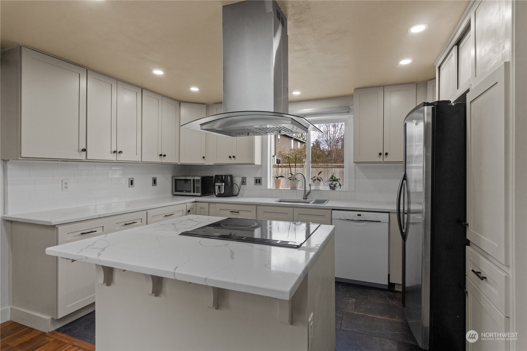 4706 Northeast 18th Street Renton, WA 98059 - Photo 10 of 26 a kitchen with stainless steel appliances a sink stove and refrigerator