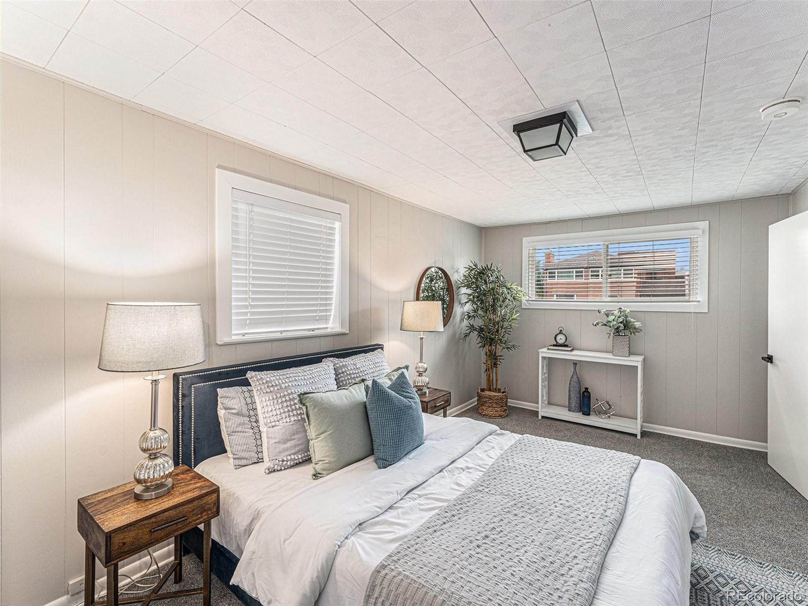 3895 Pierce Street Wheat Ridge, CO 80033 - Photo 11 of 33 a bedroom with a bed and a table in it