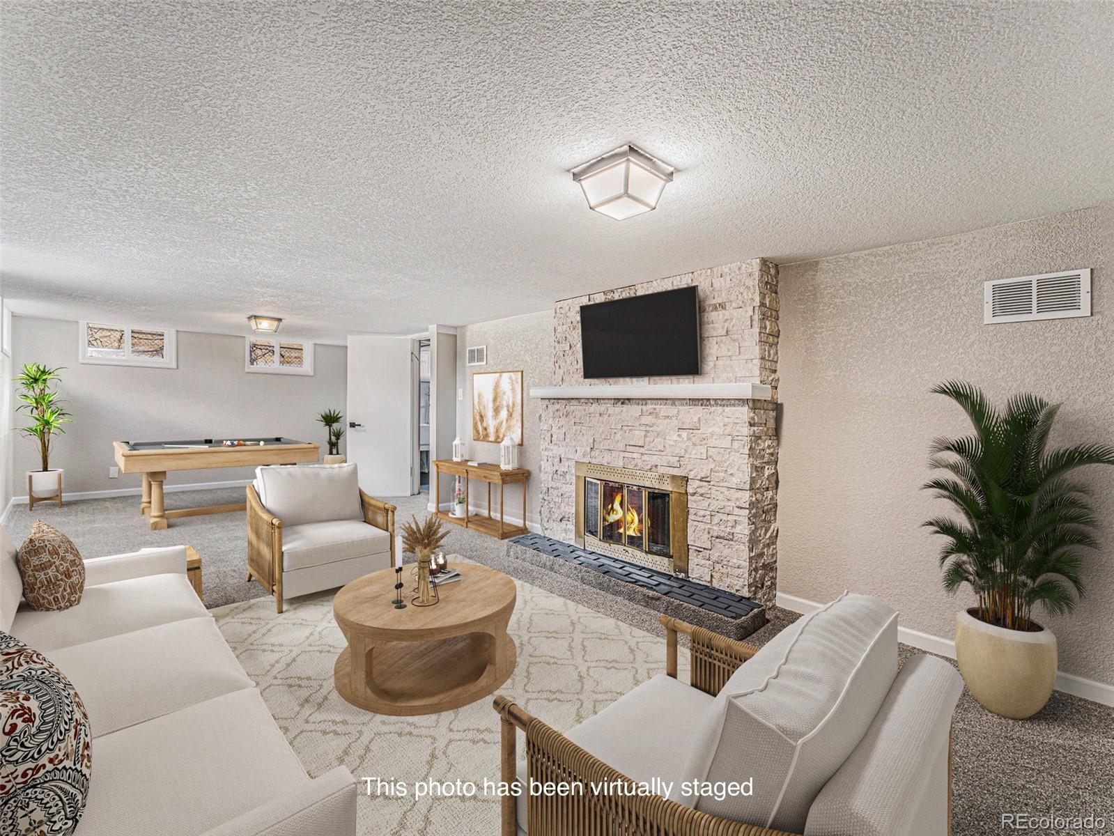 3895 Pierce Street Wheat Ridge, CO 80033 - Photo 14 of 33 a living room with furniture and a fireplace