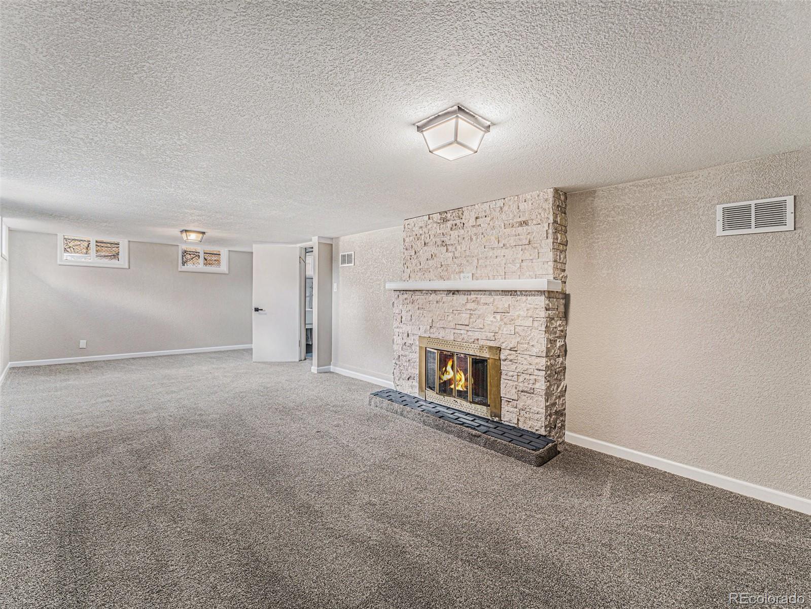 3895 Pierce Street Wheat Ridge, CO 80033 - Photo 15 of 33 a view of a livingroom with a fireplace and a window