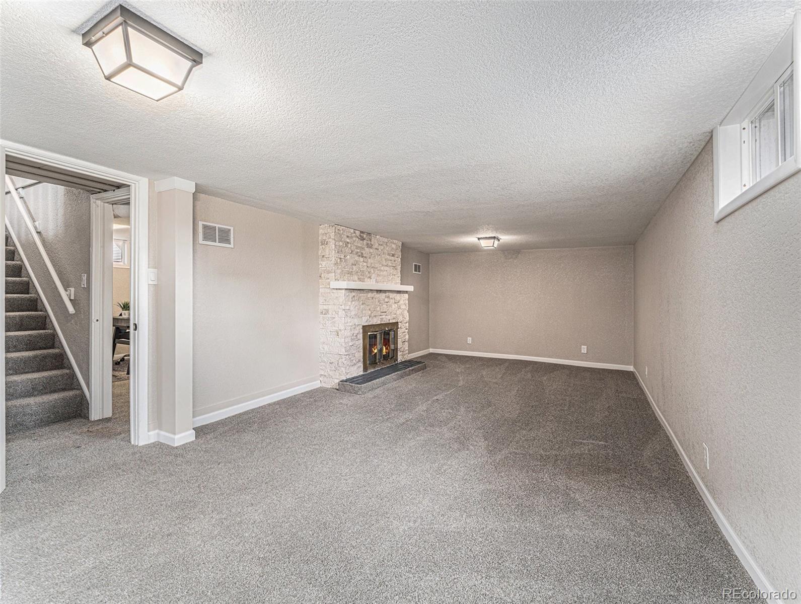 3895 Pierce Street Wheat Ridge, CO 80033 - Photo 17 of 33 an empty room with stairs and wooden floor