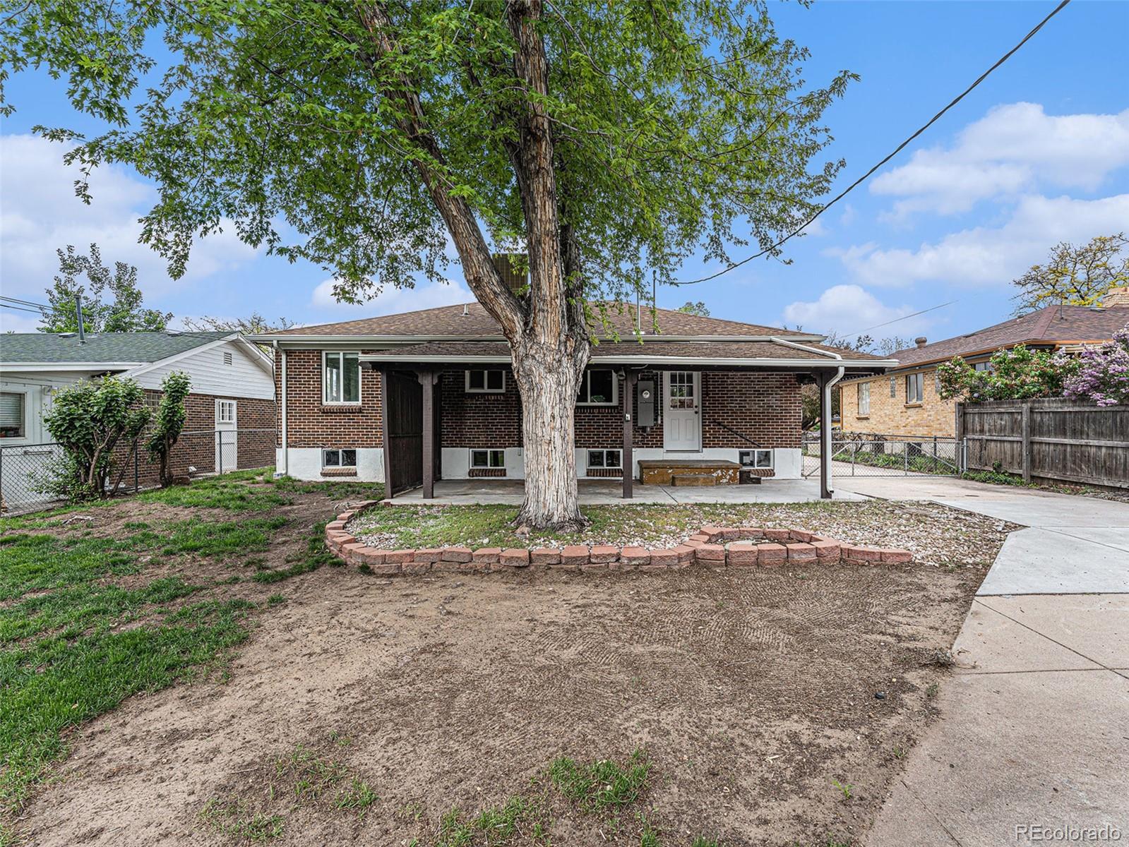 3895 Pierce Street Wheat Ridge, CO 80033 - Photo 29 of 33 a front view of a house with garden