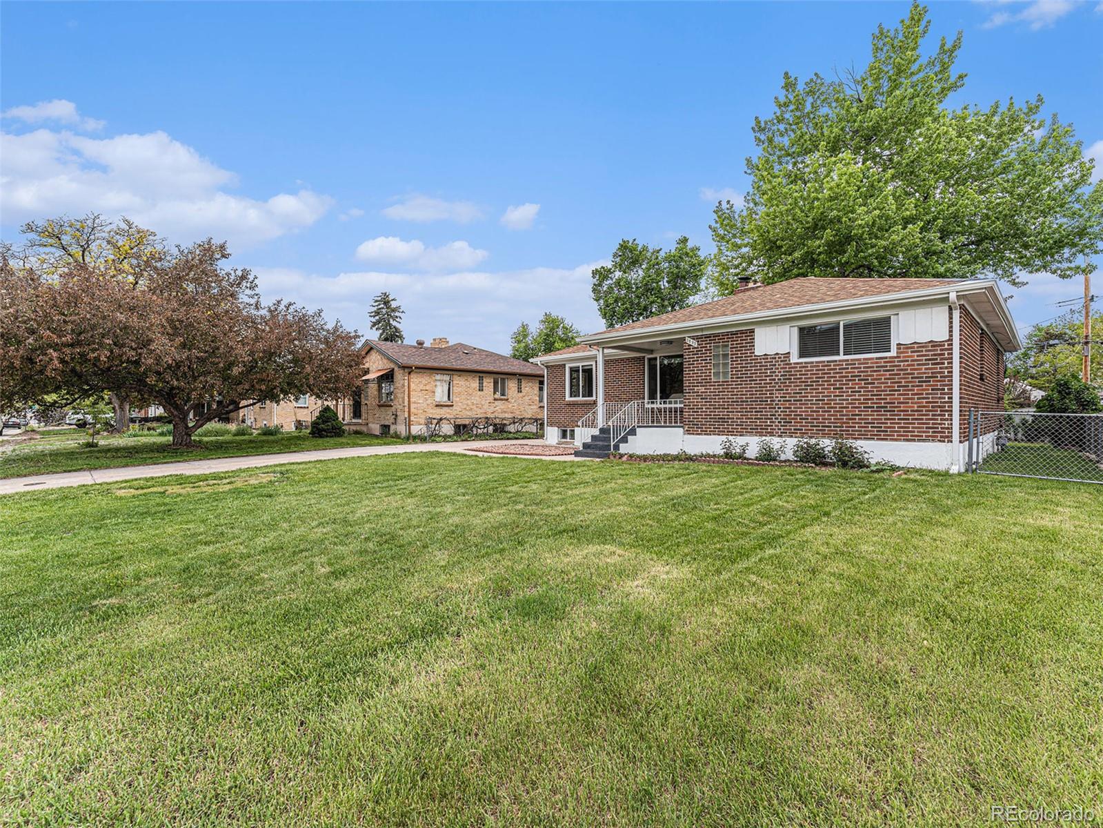 3895 Pierce Street Wheat Ridge, CO 80033 - Photo 30 of 33 a front view of house with yard and green space