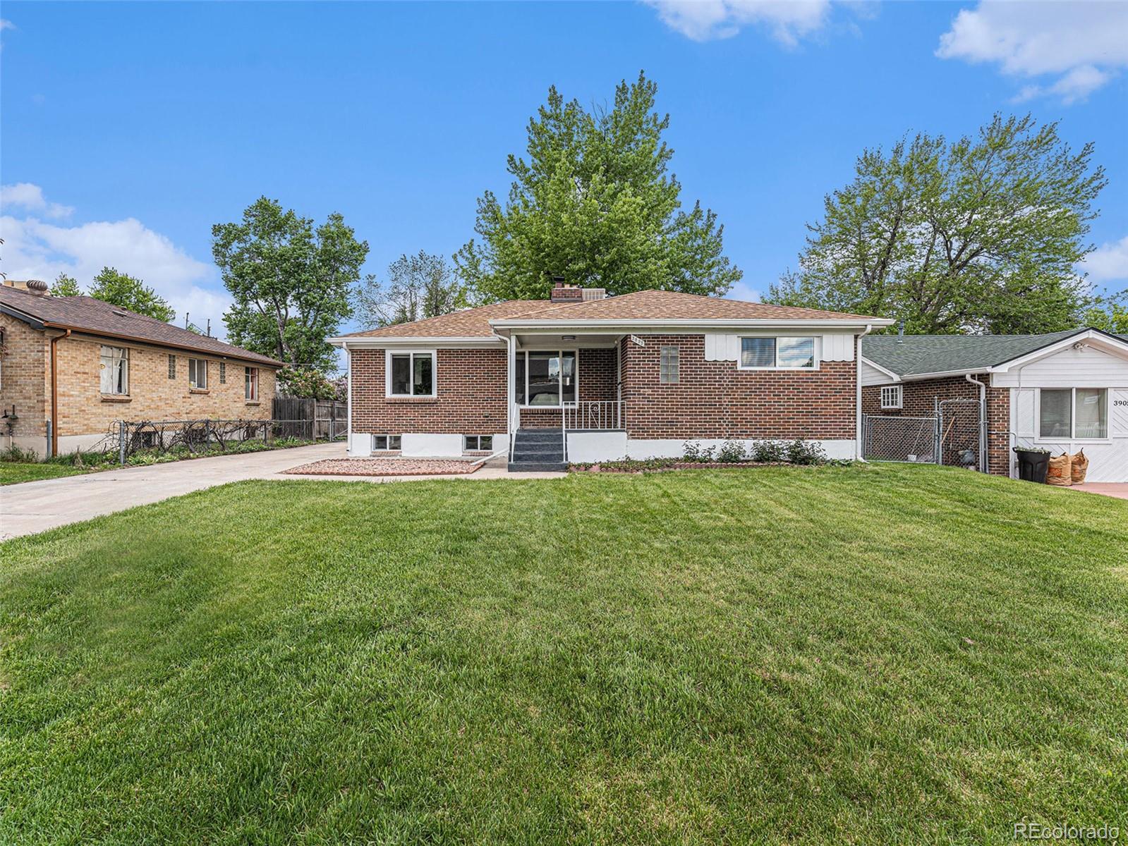 3895 Pierce Street Wheat Ridge, CO 80033 - Photo 32 of 33 a front view of house with yard and green space