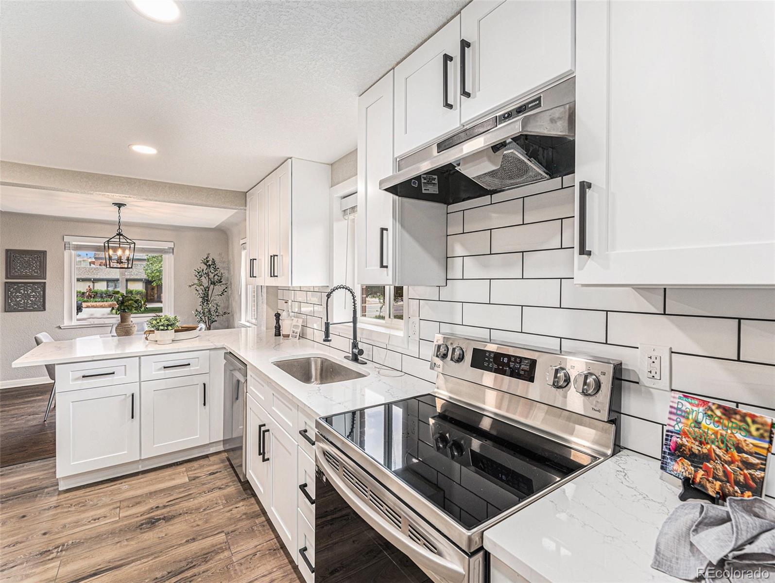 3895 Pierce Street Wheat Ridge, CO 80033 - Photo 4 of 33 a kitchen that has a sink and a stove