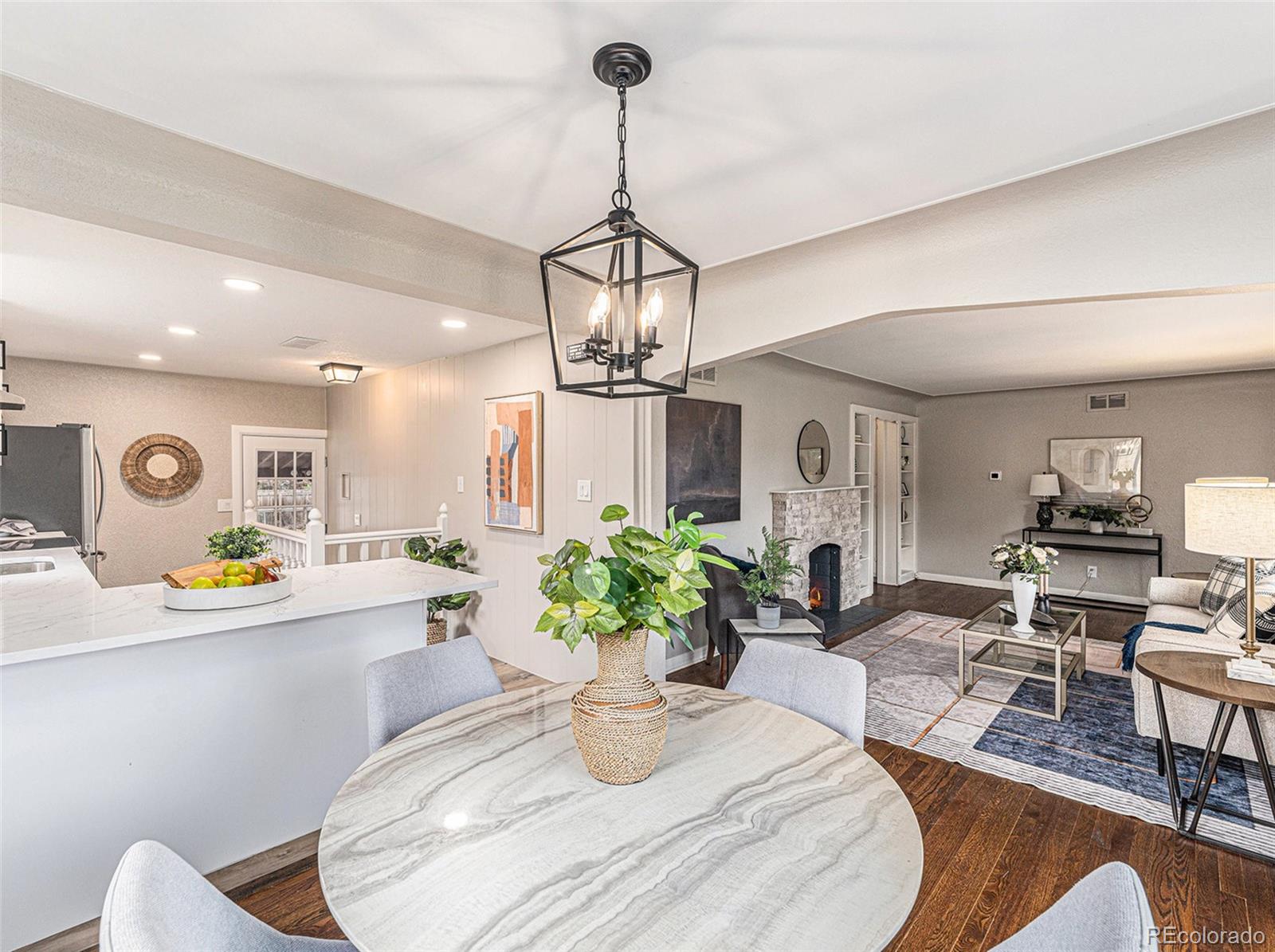 3895 Pierce Street Wheat Ridge, CO 80033 - Photo 10 of 33 a kitchen with stainless steel appliances granite countertop a sink and a chandelier