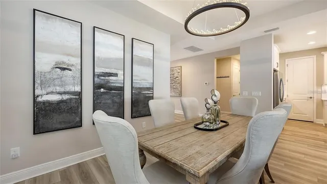 a living room with stainless steel appliances kitchen island granite countertop furniture and a flat screen tv