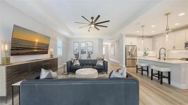 a bedroom with a bed and a flat tv screen on dresser