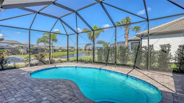 a view of a patio with a table and chairs under an umbrella