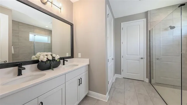 a living room with furniture a baby crib and a wooden floor