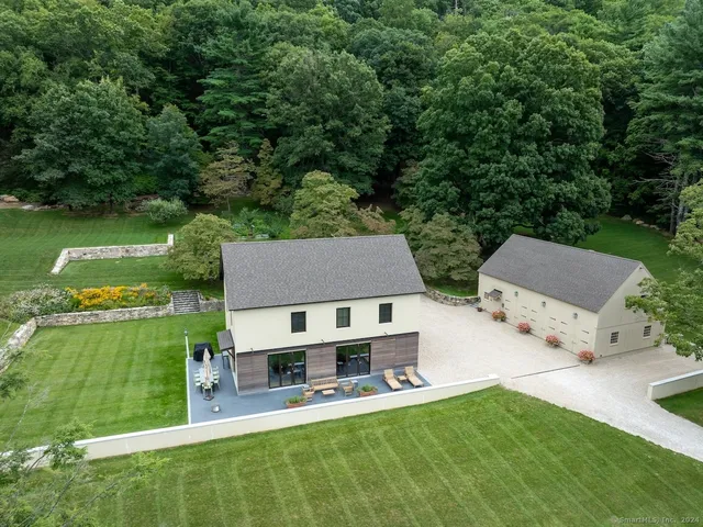 an aerial view of a house with swimming pool garden and patio