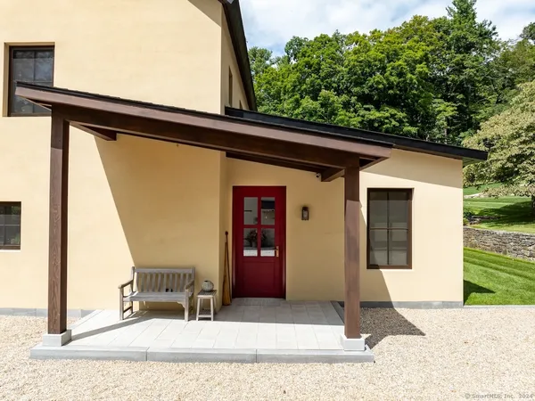a house view with a sitting space and garden