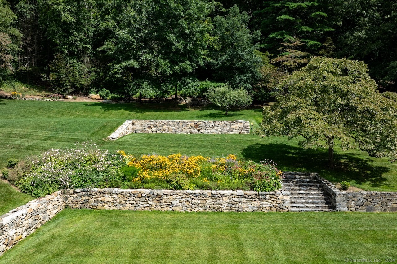 89 Under Mountain Road Canaan, CT 06031 - Photo 16 of 40 a view of a garden with a bench