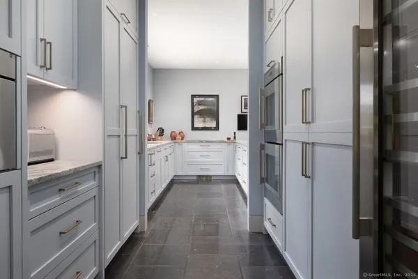 a spacious bathroom with double sink and a large mirror