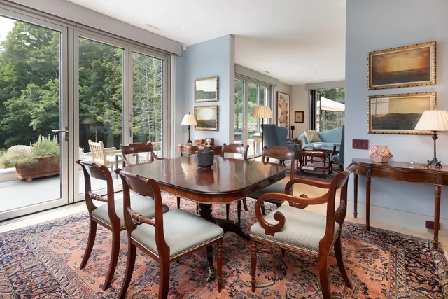 a dining room with livingroom view and wooden floor