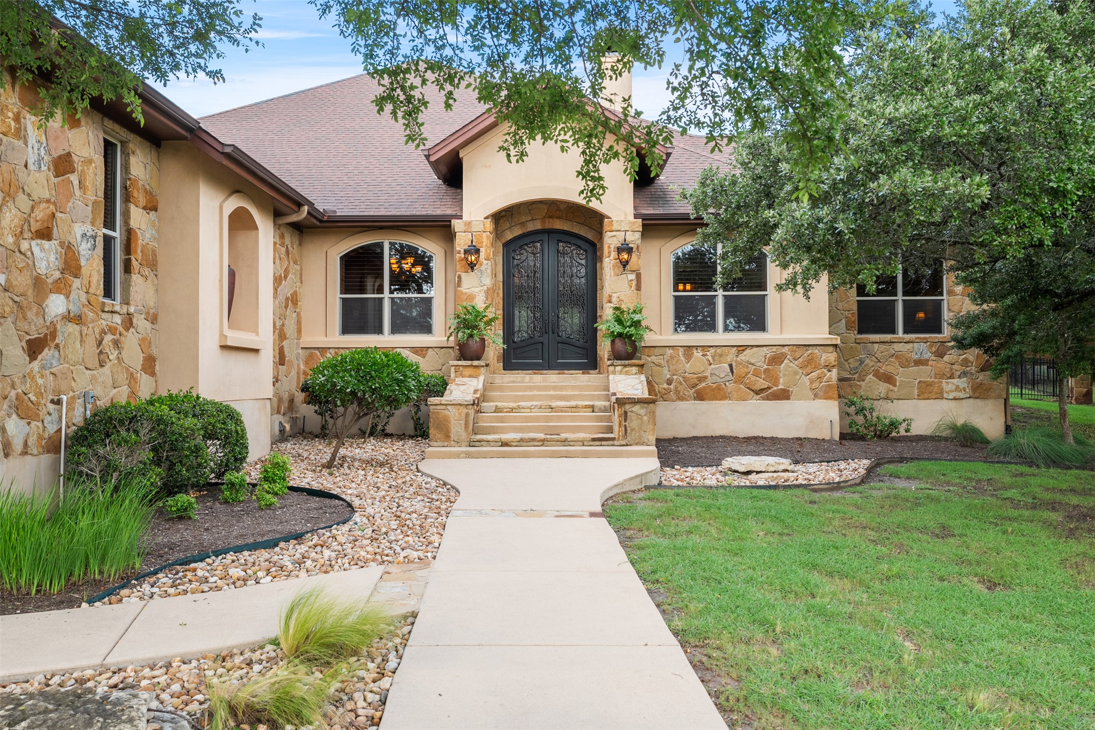 100 Portafino Lane Georgetown, TX 78633 - Photo 1 of 39 View of front of home with stone siding, french doors, a shingled roof, and stucco siding