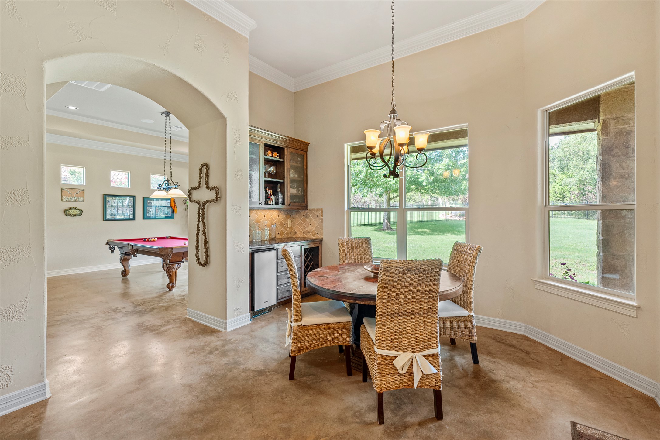 100 Portafino Lane Georgetown, TX 78633 - Photo 11 of 39 Dining space with concrete floors, plenty of natural light, billiards table, ornamental molding, and a chandelier