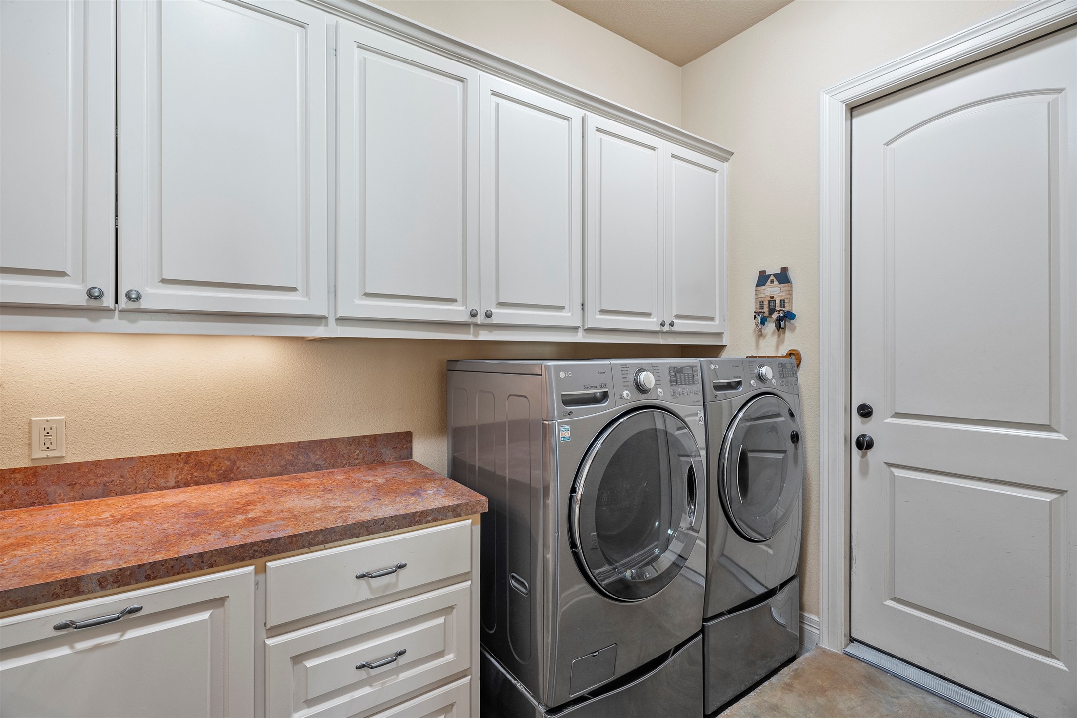 100 Portafino Lane Georgetown, TX 78633 - Photo 28 of 39 Washroom with cabinet space and washer and dryer