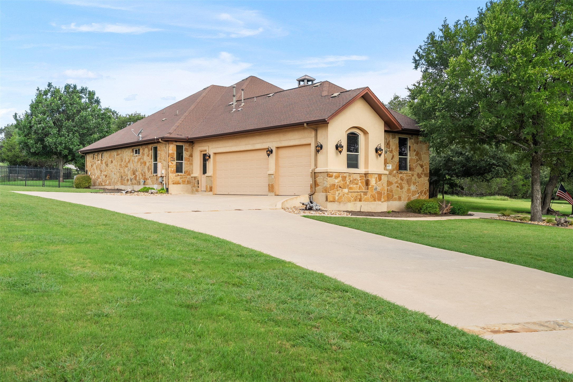 100 Portafino Lane Georgetown, TX 78633 - Photo 32 of 39 View of front of property featuring stone siding, a garage, stucco siding, and driveway