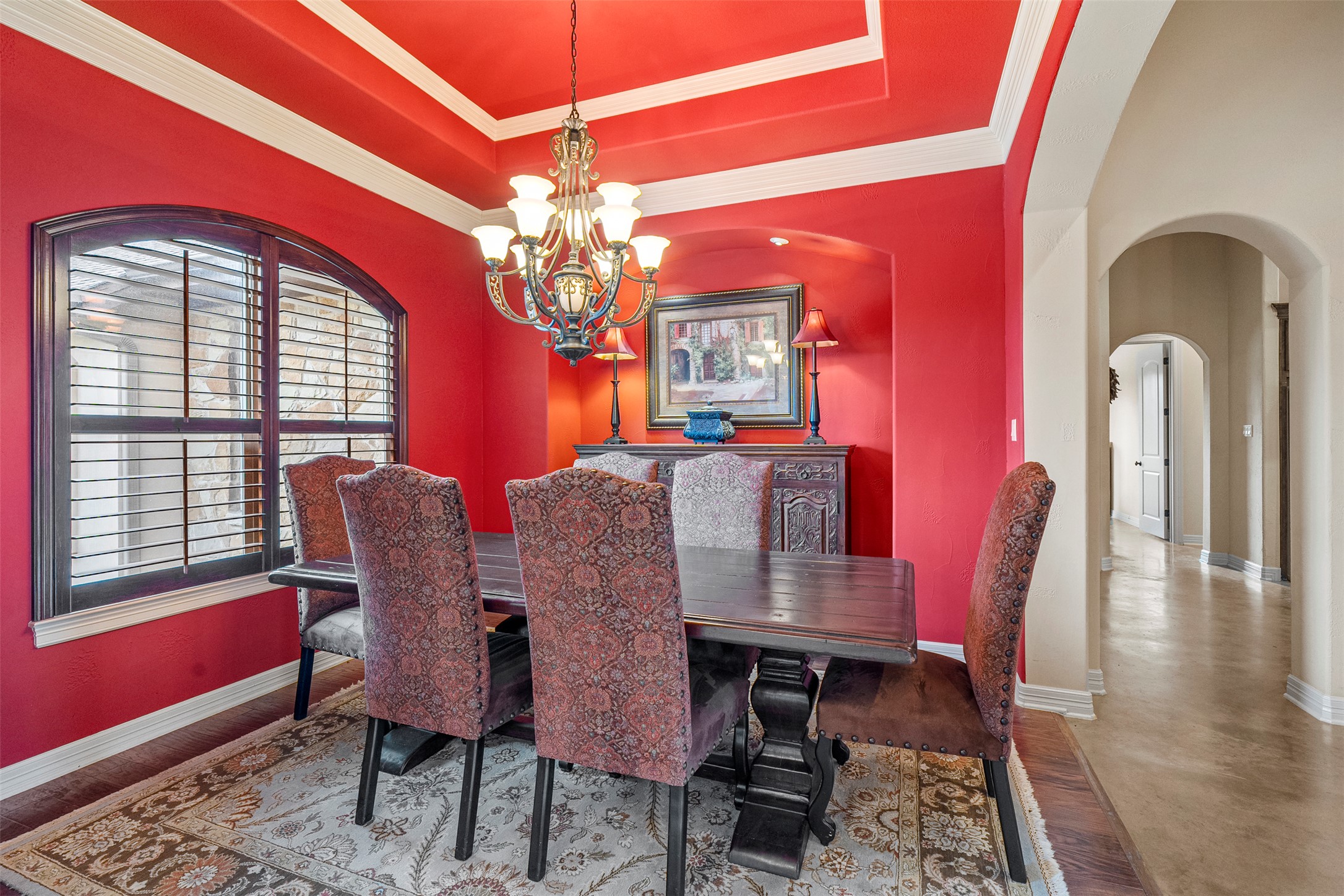 100 Portafino Lane Georgetown, TX 78633 - Photo 38 of 39 Dining room featuring arched walkways, a chandelier, a tray ceiling, and crown molding