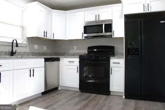 a kitchen with a sink and a stove top oven