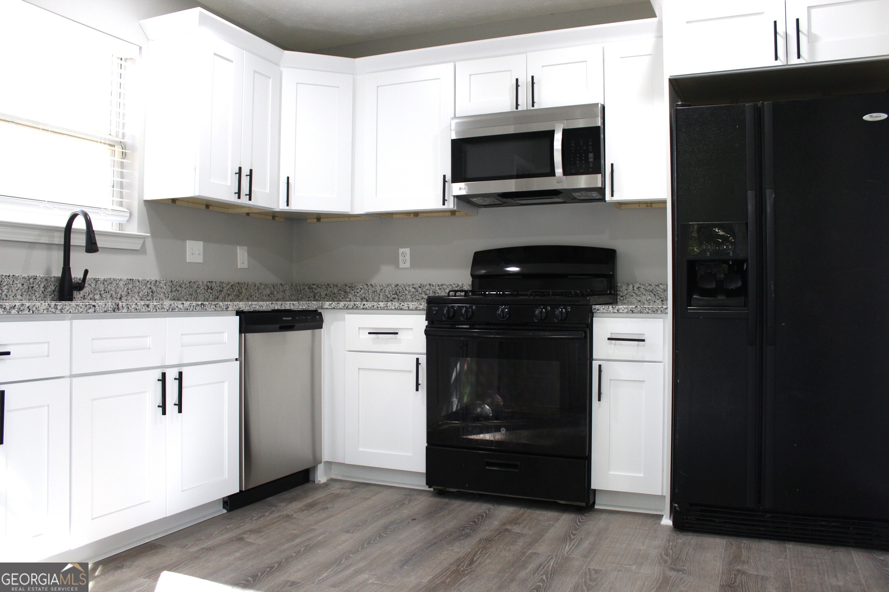 2640 Field Spring Drive Lithonia, GA 30058 - Photo 5 of 11 a kitchen with a sink and a stove top oven