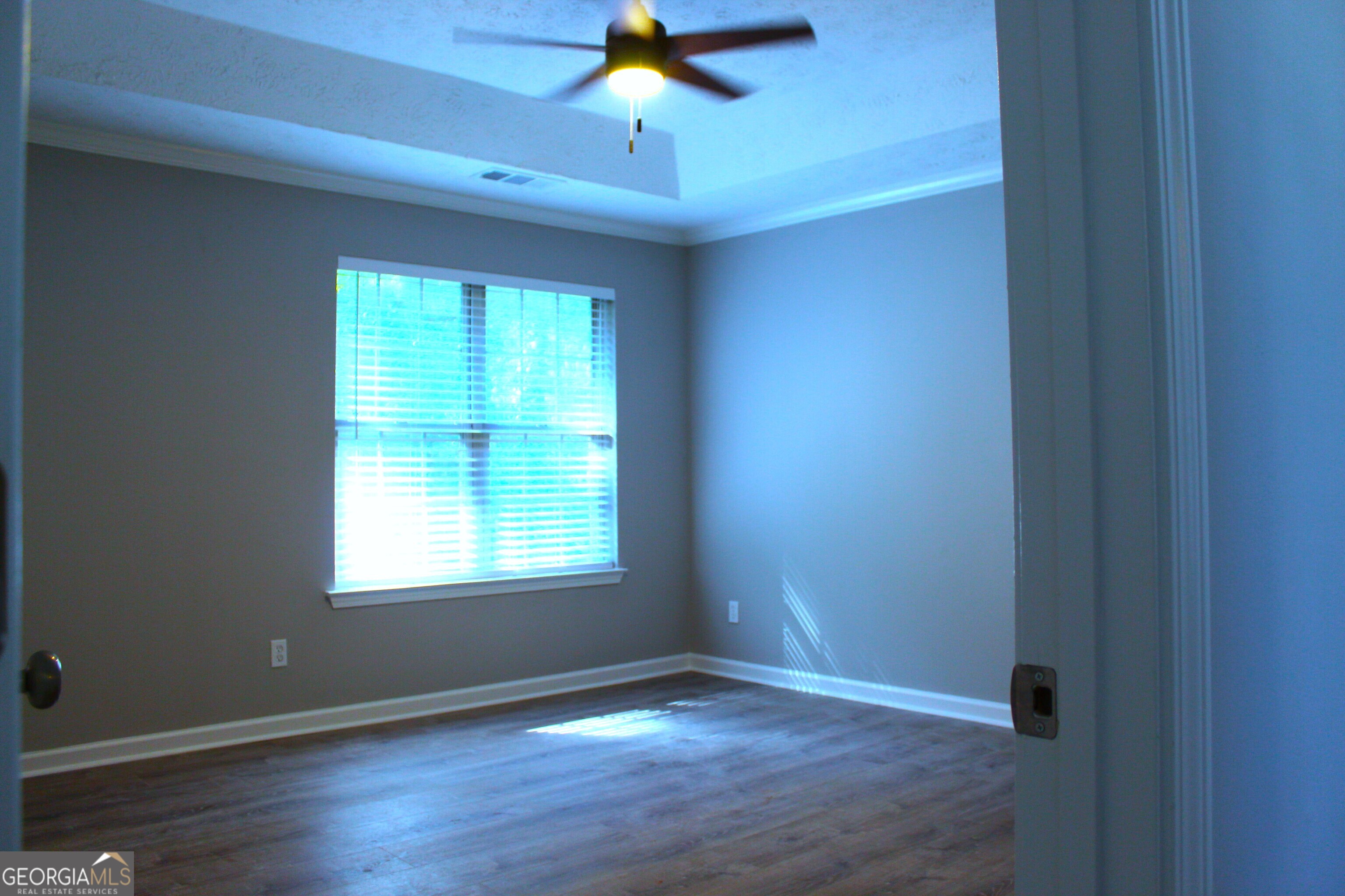 2640 Field Spring Drive Lithonia, GA 30058 - Photo 6 of 11 a view of an empty room with a window and wooden floor